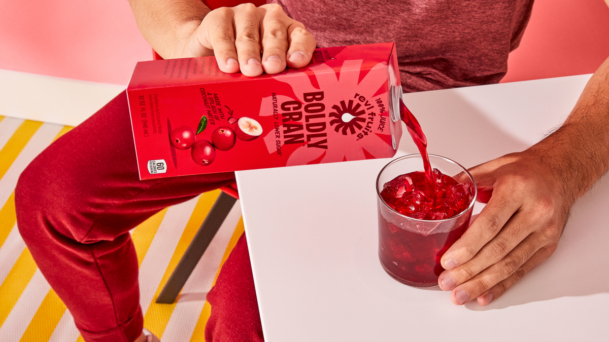 boldly cran juice being poured into a glass