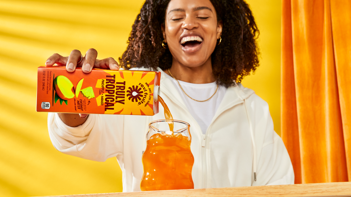 truly tropical juice being poured into a glass